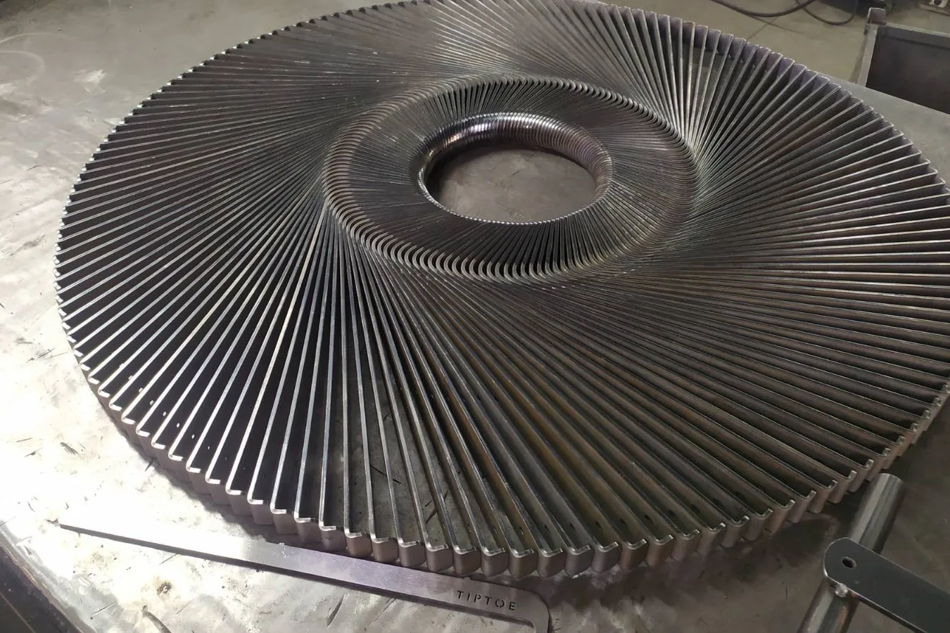 Large rotary vane assembly with several hundred radial blades welded to a central ring